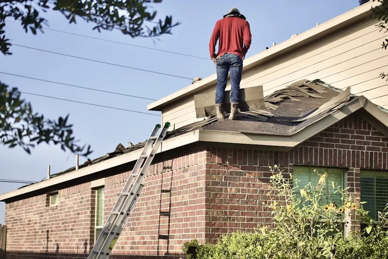 Professional roofer working on a residential roof in Natomas Creek